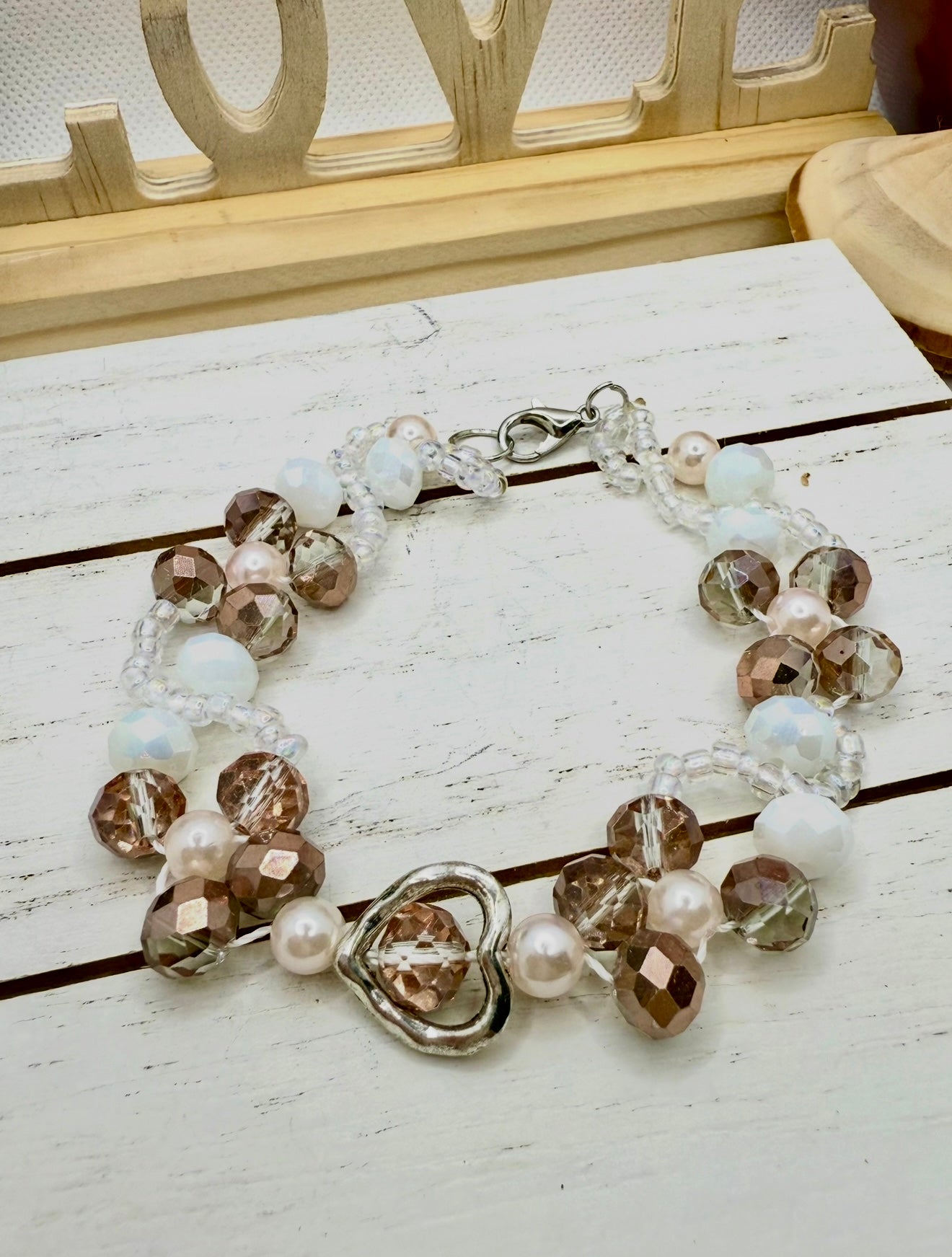 Champagne in white glass beads with hollow heart charms