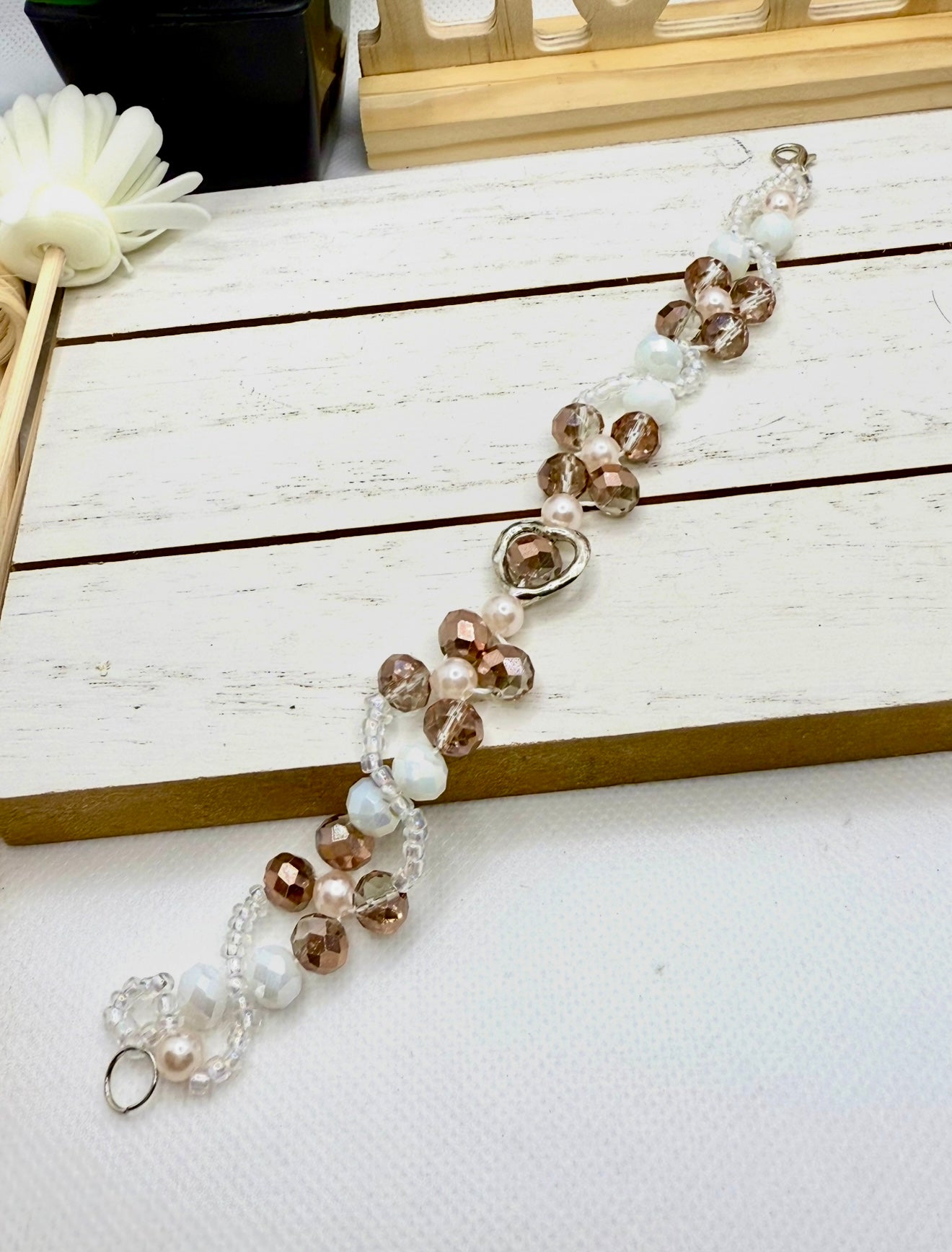 Champagne in white glass beads with hollow heart charms